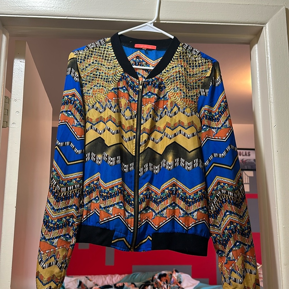 Multicolored design light jacket with gold, blue, black, & orange.